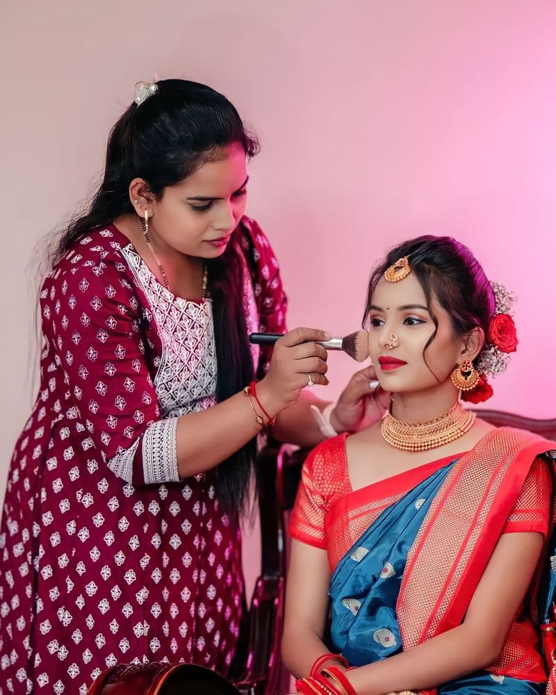 Bride getting makeup done at Niharika Beauty World studio